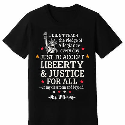 black T-shirt featuring a bold white and red graphic of the Statue of Liberty and the quote I didnt teach the Pledge of Allegiance every day just to accept anything less than liberty justice for all — In my classroom and beyond.